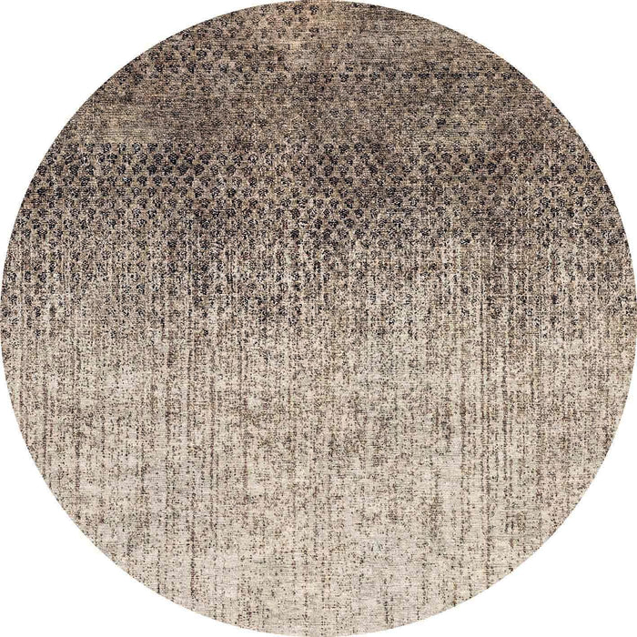 Round rug with a dark brown to beige ombre gradient and a distressed, textured abstract pattern.